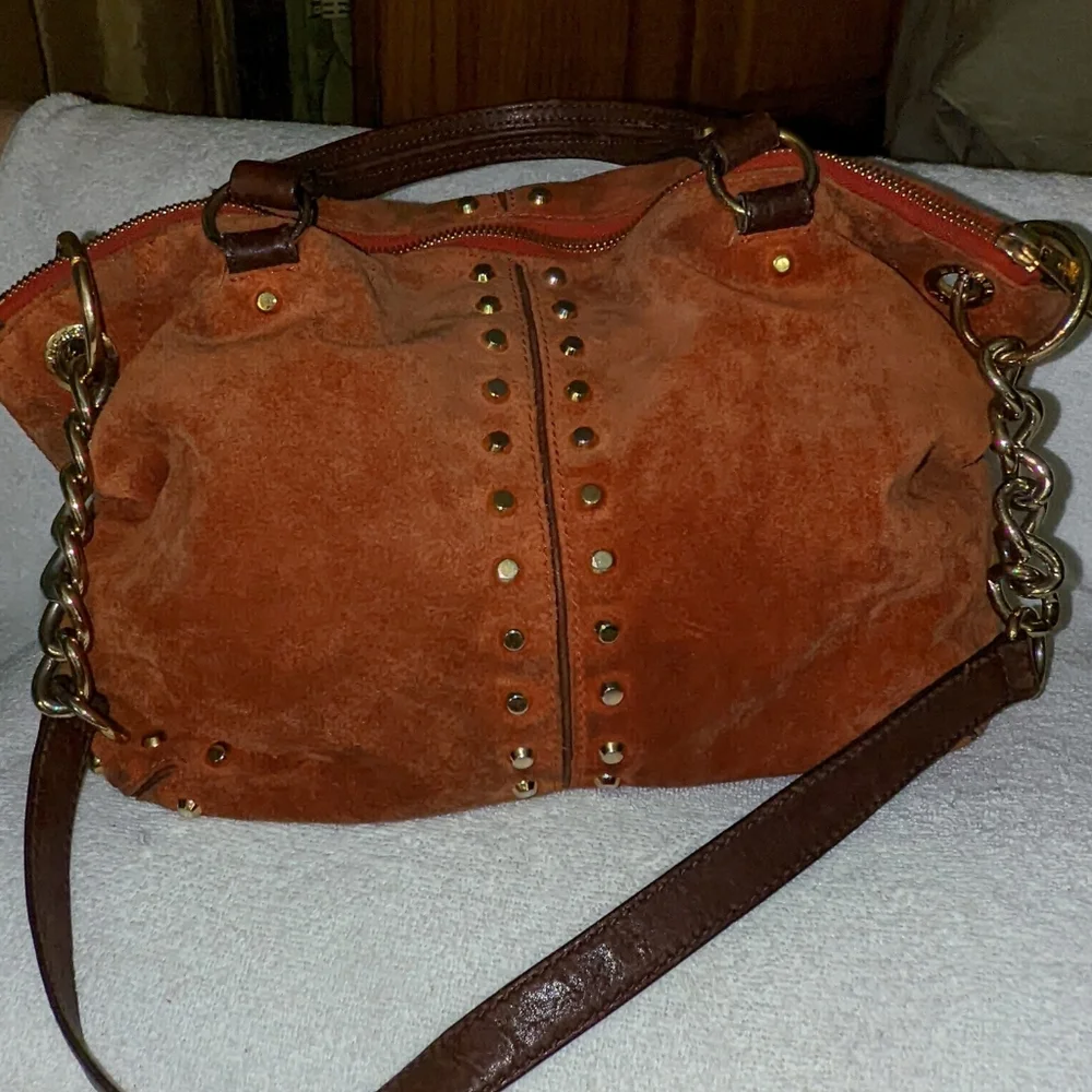 Michael Kors orange suede studded slouchy shoulder bag.